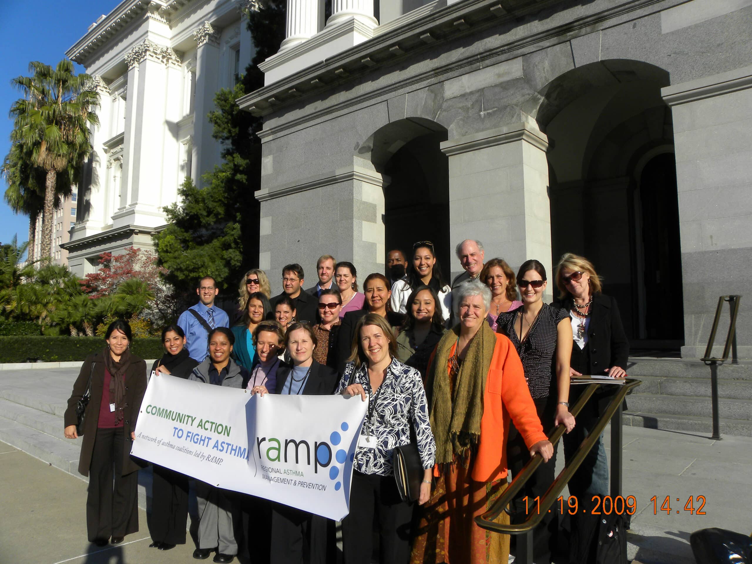 CAFA meeting attendees standing on steps with banner